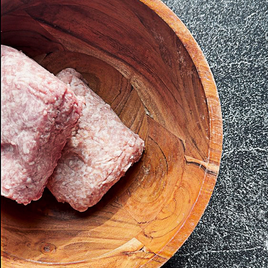 ground pork in a bowl ready to be mixed with other ingredients for maple bacon meatloaf