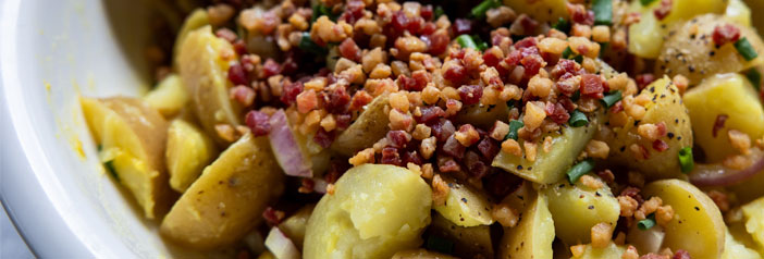 crispy pancetta potato salad with herbs, served warm