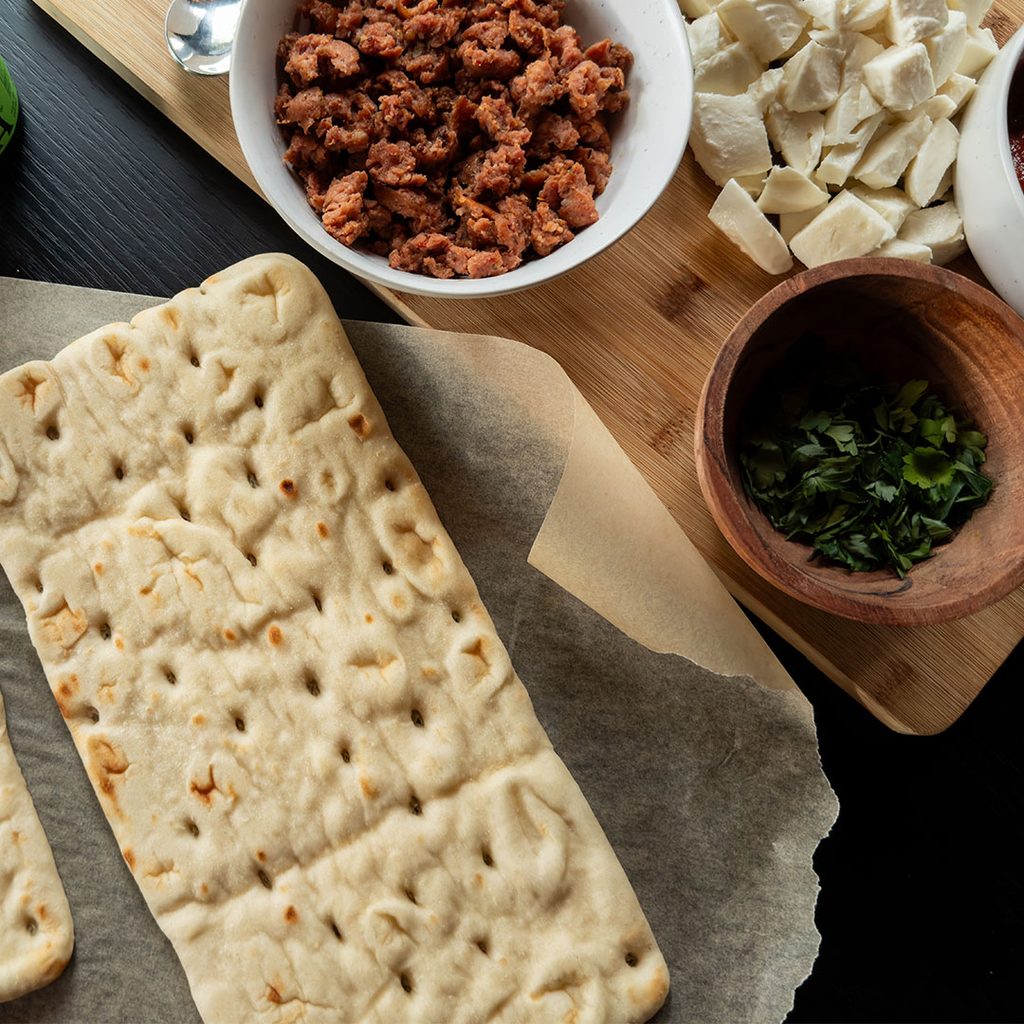 flatbread and prepped mozz and sausage